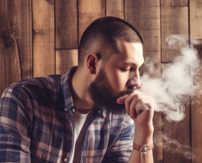 stock photo vaping man with wooden background 2 1